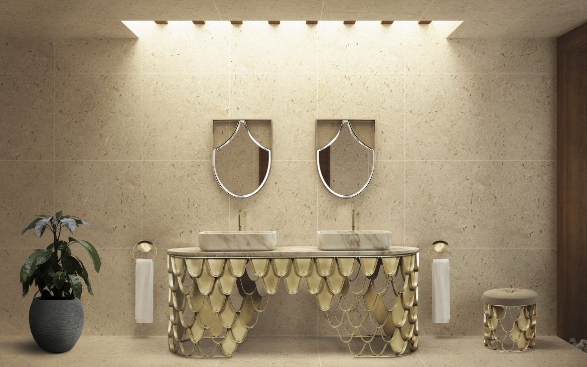 bathroom with gold details from the washbasin, the towel racks and the stool